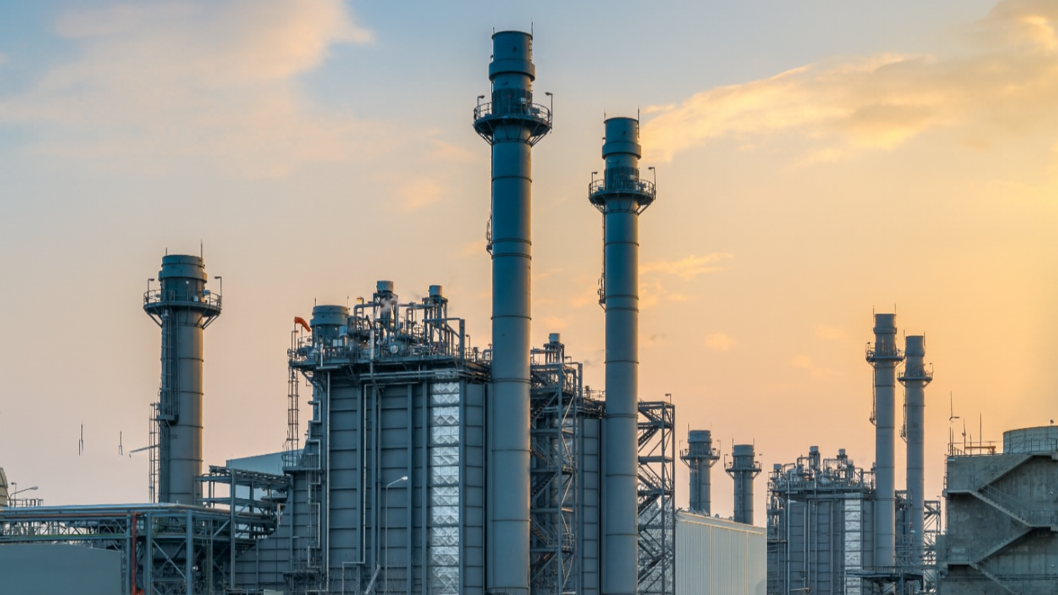Modern combined cycle gas turbine power plant at golden hour